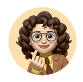 Cartoon avatar of a person with curly brown hair, wearing glasses, a brown suit, yellow shirt, and brown tie. The person is smiling and making a finger-heart gesture with their right hand.